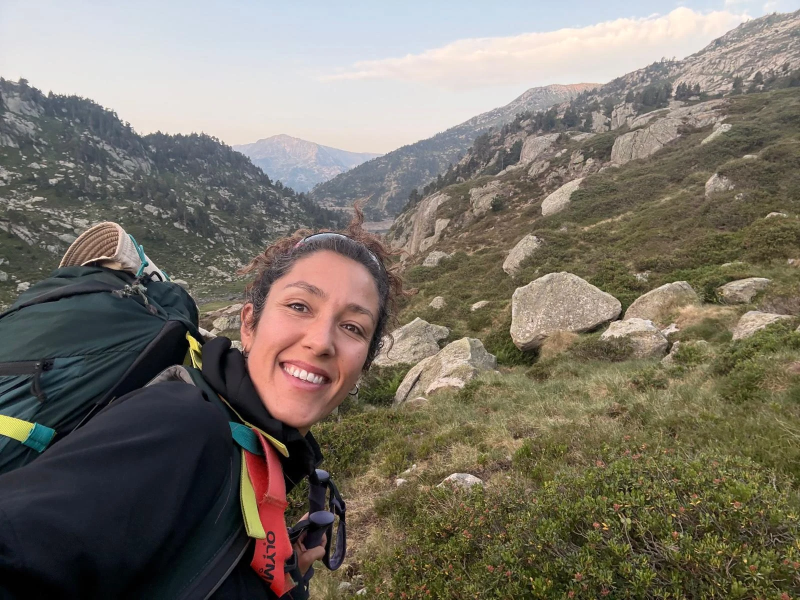 Helena smiling while hiking in the mountains